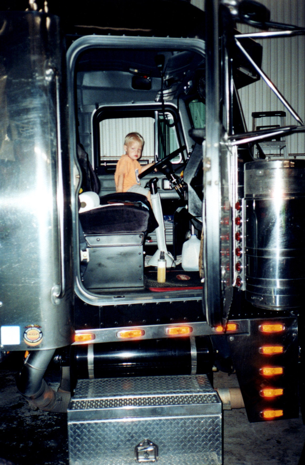 Child in the cab of a Jusczak truck