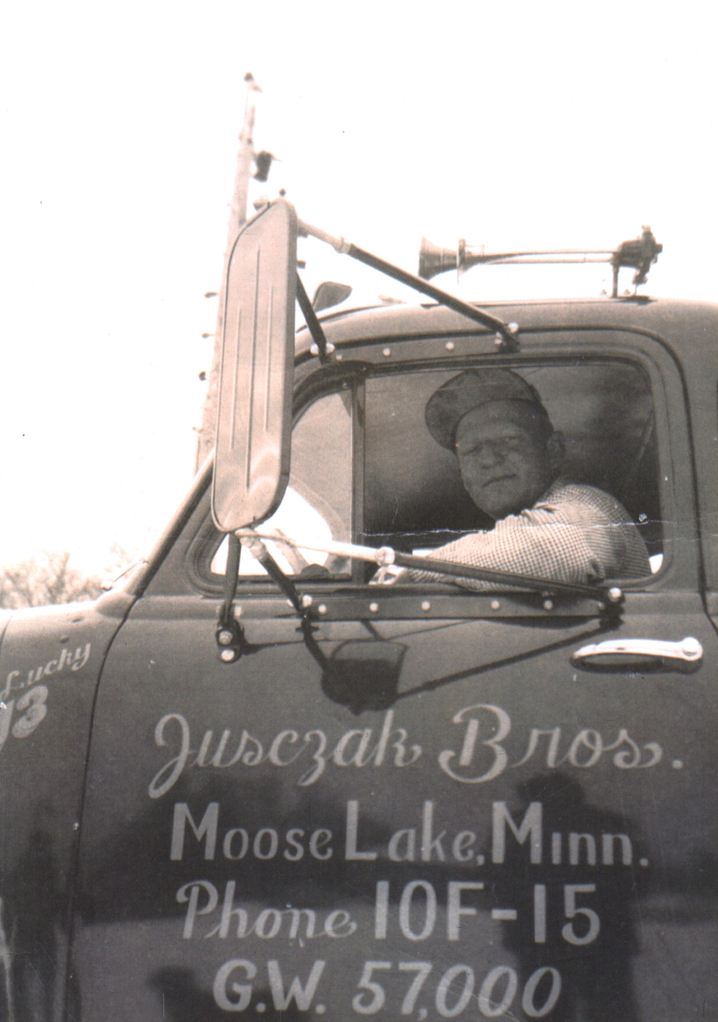 Frank Jusczak leaning from the cab of an early Jusczak Bros truck