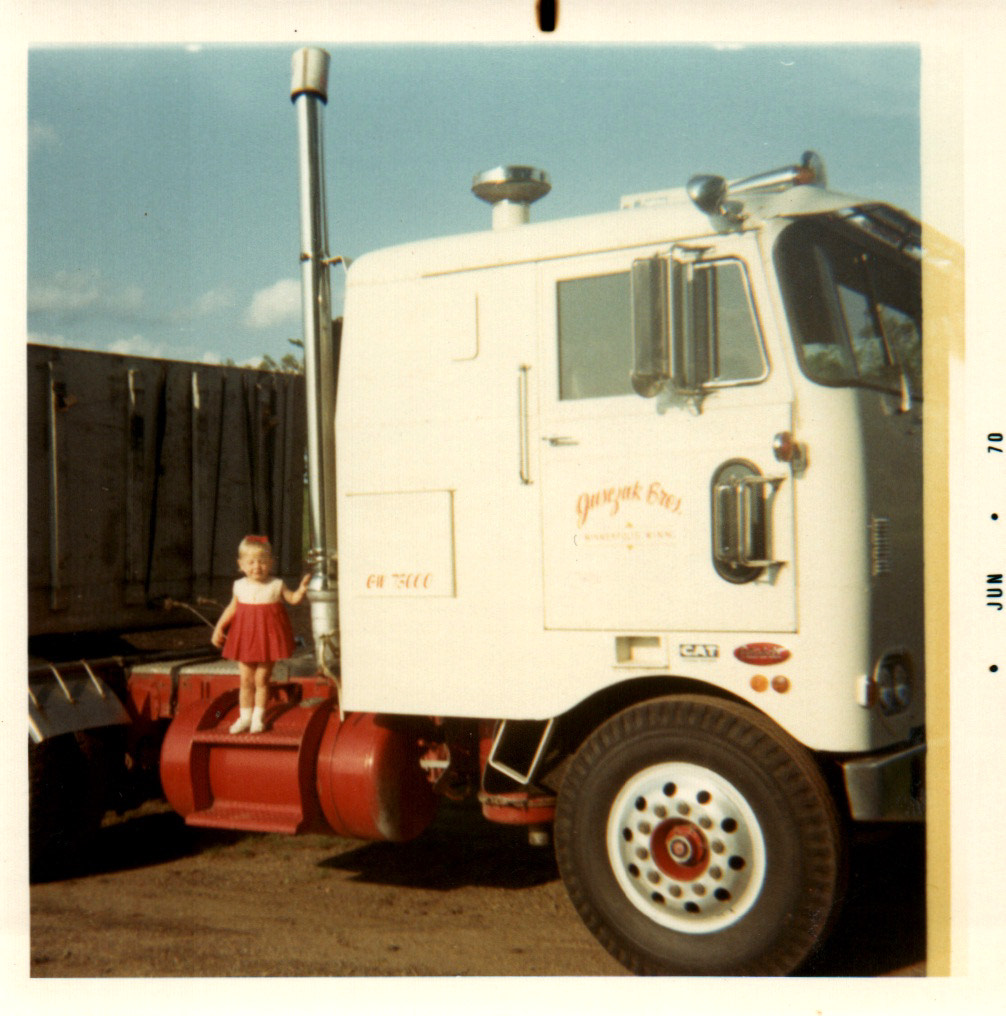 Child standing beside a Jusczak cab-over truck