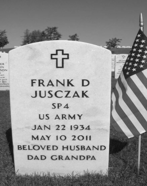 Headstone of Frank D Jusczak, SP4 US Army, 1934 to 2011, with an American flag